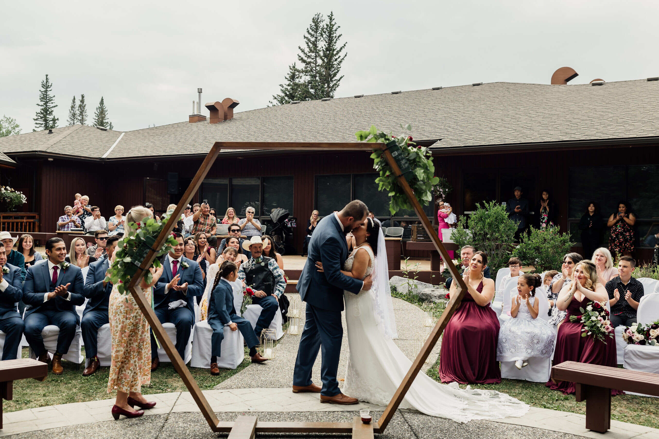 couple share first kiss at redwood meadows wedding ceremony